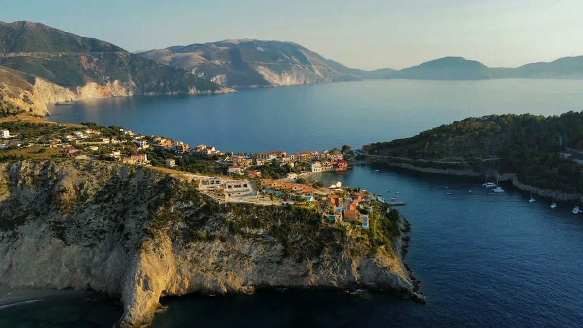 A coastal village nestled between green cliffs and the sea